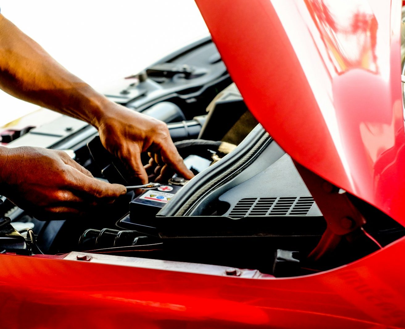 person fixing car during daytime